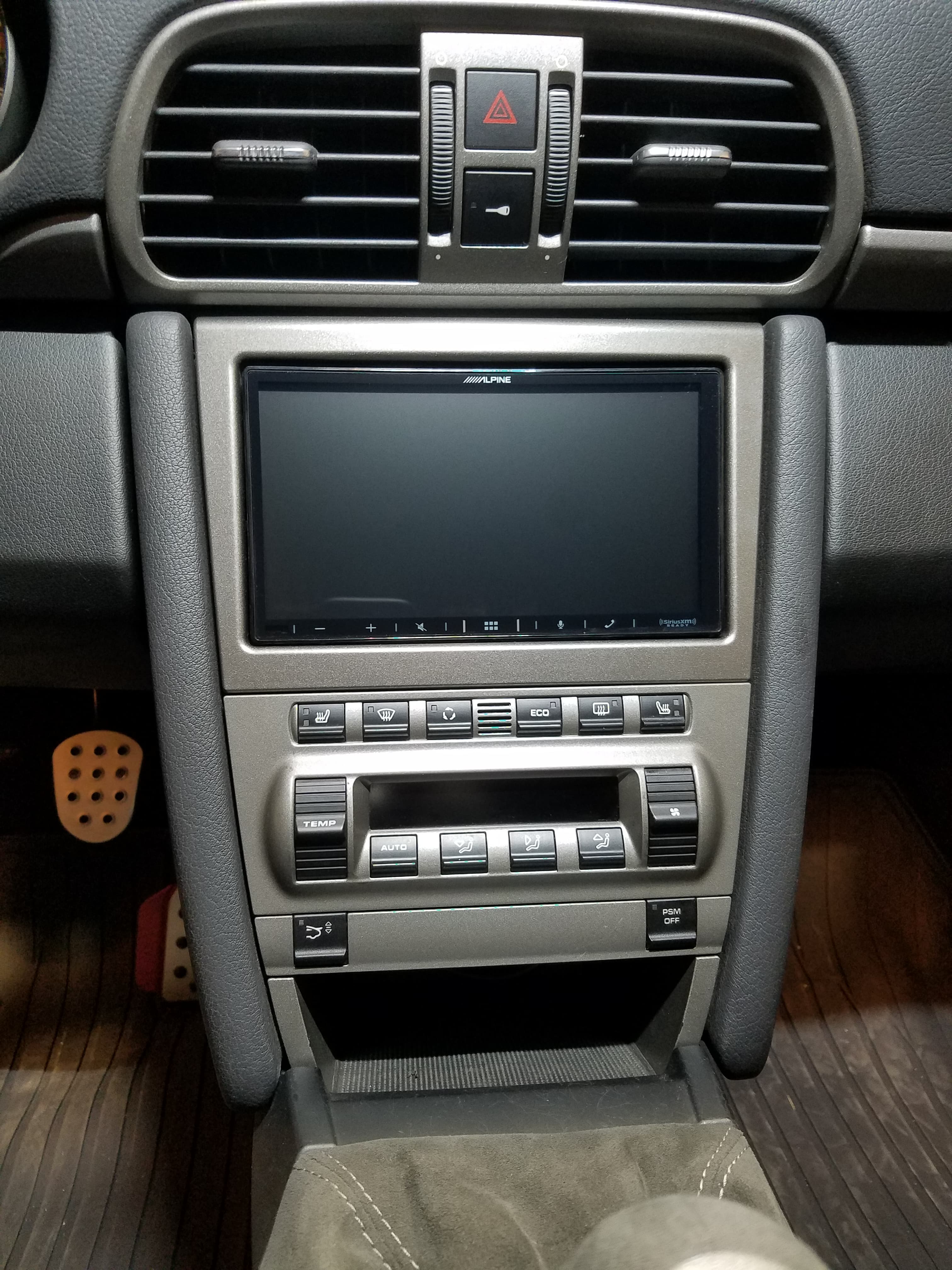 Silver car center console with an Alpine touchscreen, climate controls, and upper air vents.