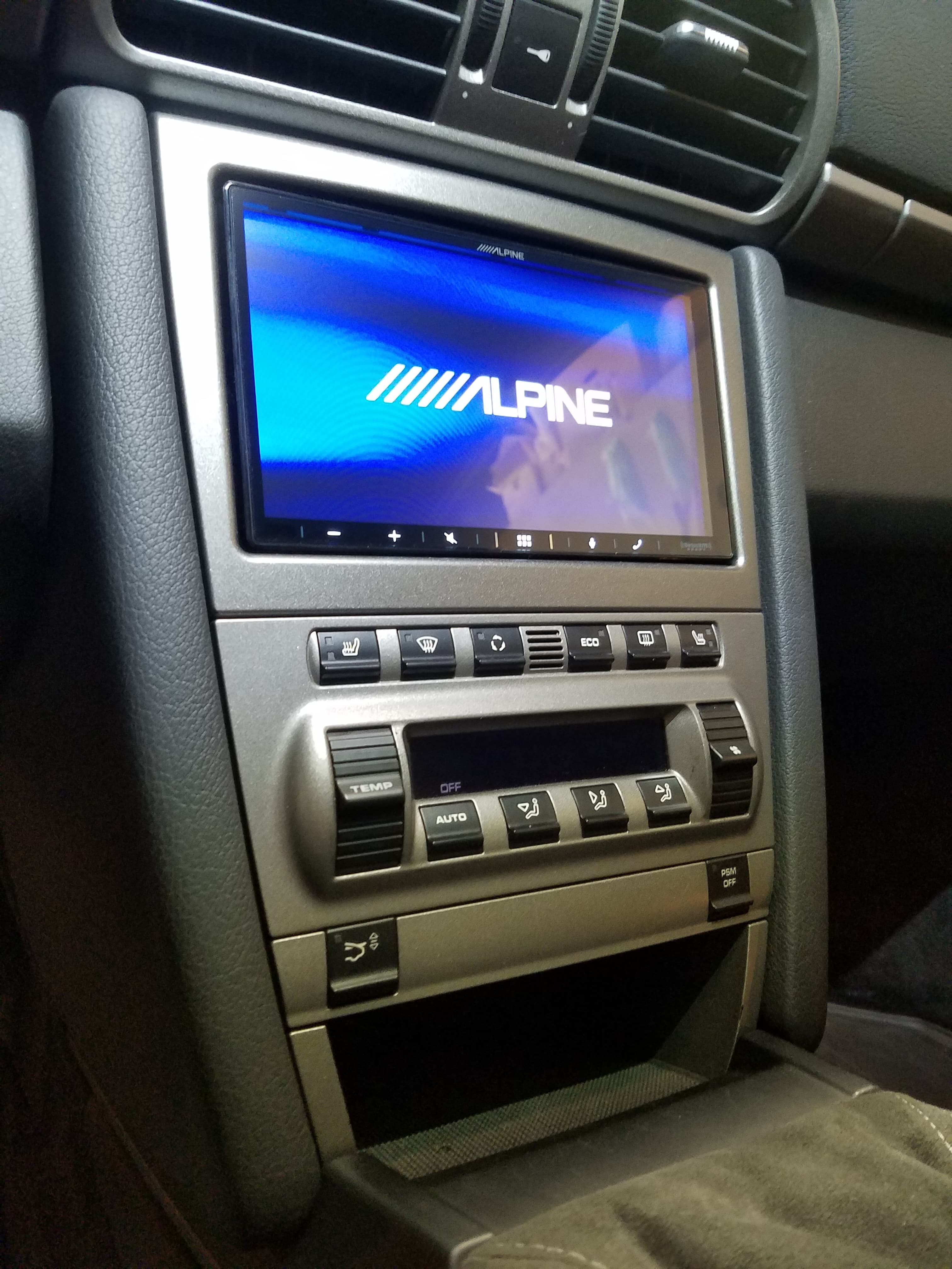 Alpine touchscreen display in a silver car console after CarPlay integration